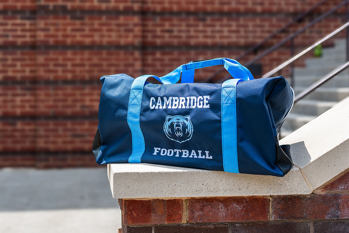 Cambridge Football team travel bags with the Bear logo