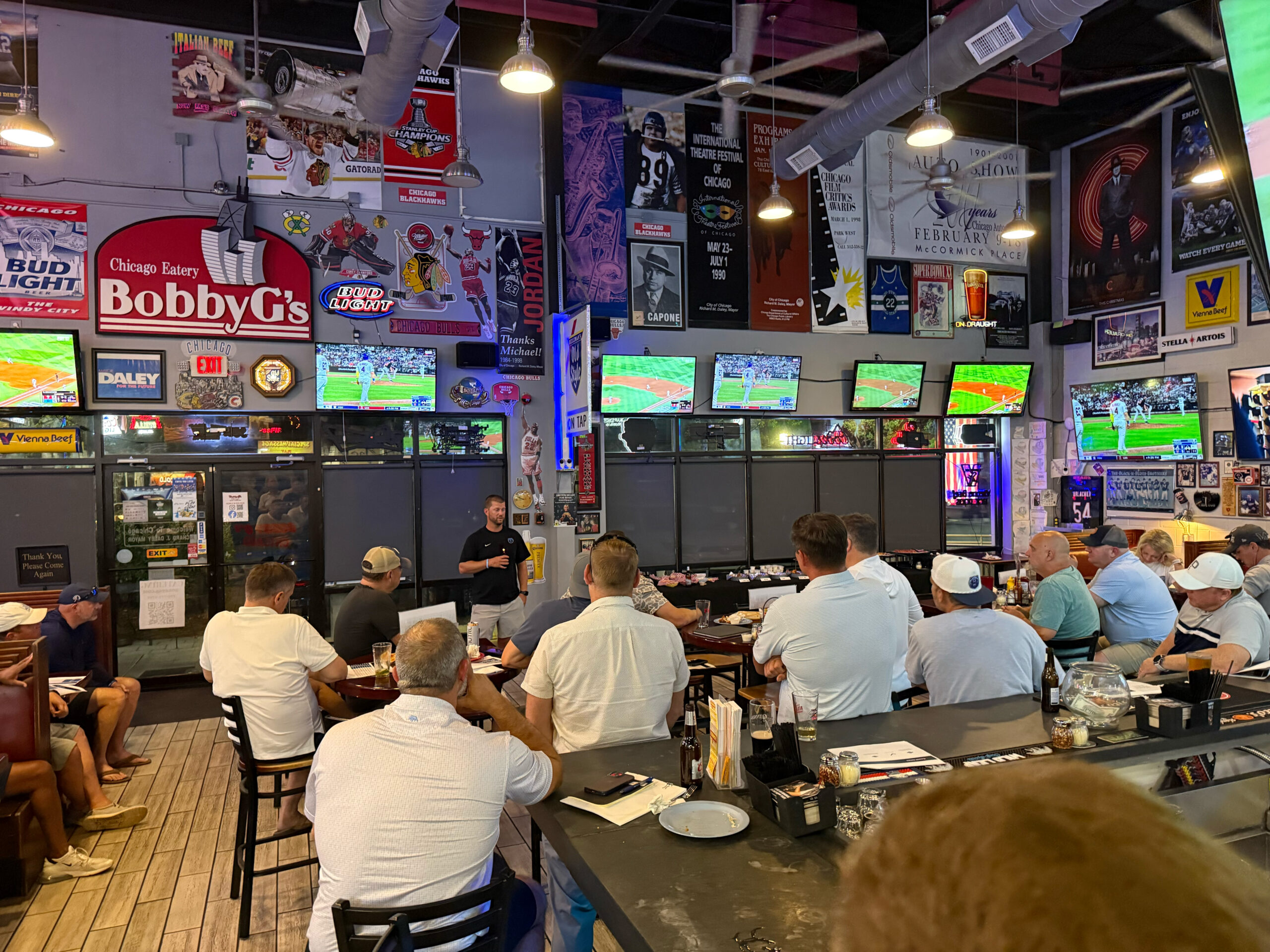 Bear Gridiron Club members listening to Coach Jones at the Member Mixer
