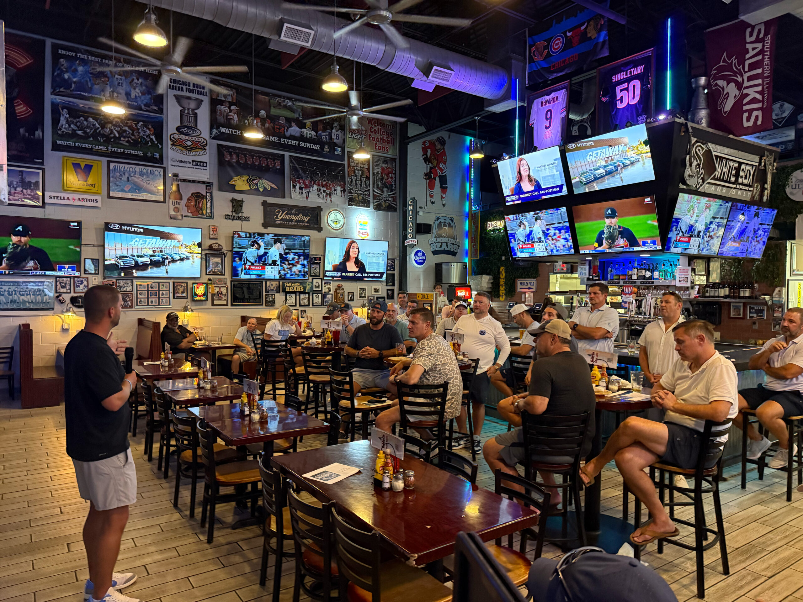 Bear Gridiron Club members gathered around tables at Bobby G's