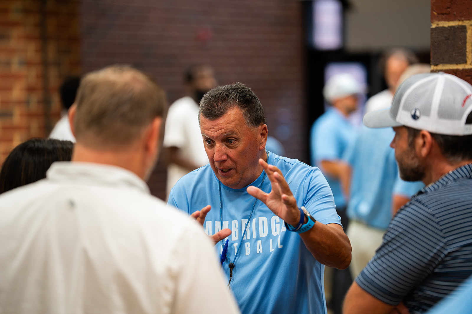 Coach talking with parents at the Cambridge Bears team dinner
